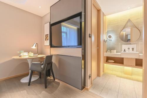 a small room with a table and a sink at Atour Hotel Beijing Joy City Chaoyang Road in Beijing