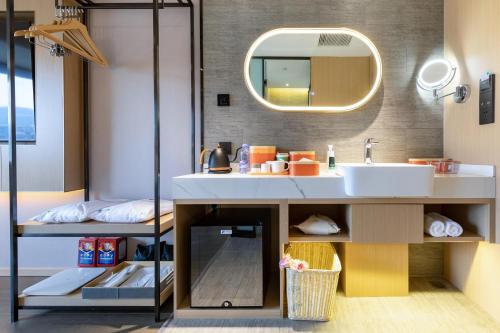 a bathroom with a sink and a mirror at Atour X Hotel Jinan Quancheng Plaza in Jinan