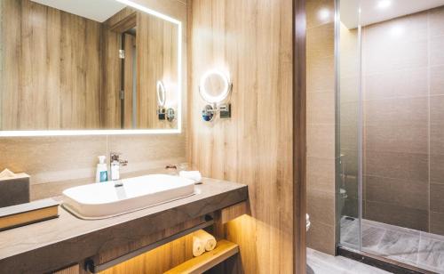 a bathroom with a sink and a shower at Atour Hotel Hongqiao Hub National Exhibition Center Shanghai in Shanghai