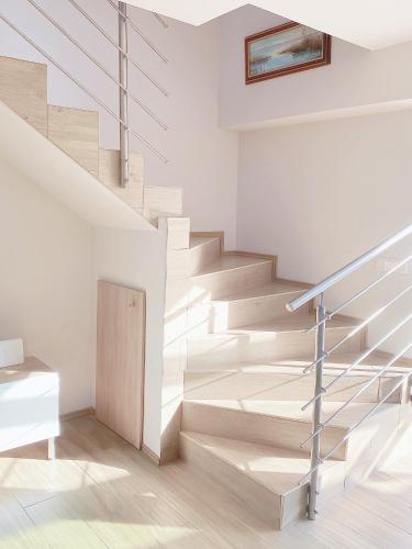 a staircase in a house with white walls and wooden floors at Piros Vendégház in Tihany