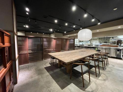 a large dining room with a large wooden table and chairs at Kusatsu Daiichi Hotel in Kusatsu