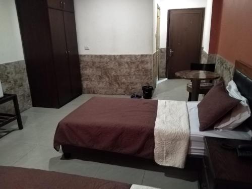 a bedroom with a large bed in a room at Amman Palace Hotel in Amman