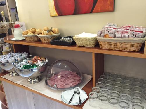 a shelf with food and other items on it at Hotel Arcobaleno in Vimodrone