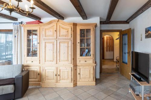 a large wooden cabinet in a living room at Meggis Bergblick in Bolsterlang