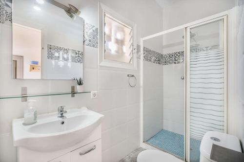 a white bathroom with a sink and a shower at Villa Can Sureda in Pollença