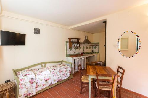 1 dormitorio con cama, mesa y espejo en Albergo Villa San Michele en Greve in Chianti