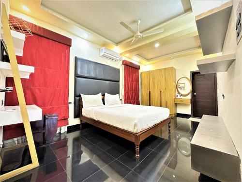 a bedroom with a bed and a sink in it at Lotus-Explore Kerala 365 in Trivandrum