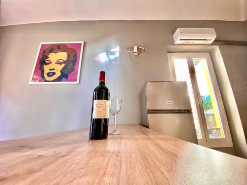 - une bouteille de vin assise sur une table avec un verre de vin dans l'établissement Lovely & sunny loft heart of Nice with A/C!, à Nice