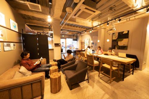 a group of people sitting in a room at Glamping Tokyo Asakusa in Tokyo