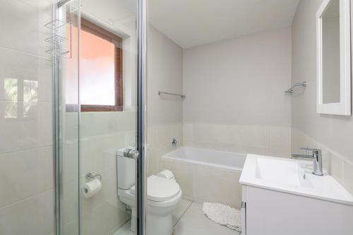 a white bathroom with a toilet and a sink at San Lameer Villa 2510 - 1 Bedroom Classic - 2 pax - San Lameer Rental Agency in Southbroom