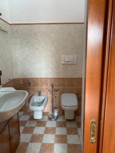 a bathroom with a toilet and a sink at L'Attico dei Sogni in San Gimignano