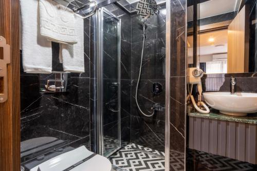 a bathroom with a shower and a toilet and a sink at THE BOSFOR HOTEL in Istanbul