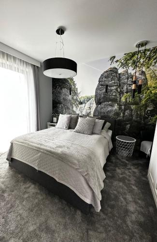 um quarto com uma cama grande e uma parede de pedra em Apartament Pod Ojcowem em Skała