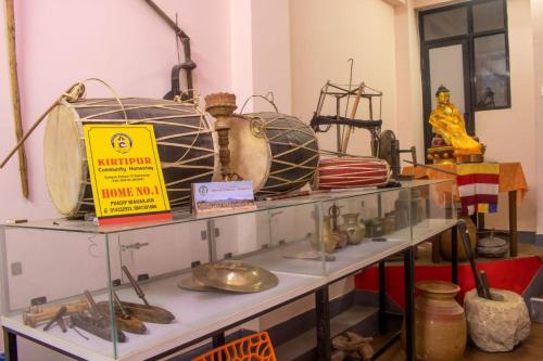 a shelf filled with lots of items in a room at Kirtipur Community Homestay in Kirtipur