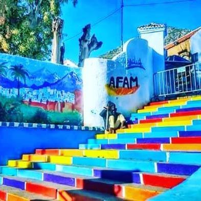 a rainbow colored staircase in front of a building at DAR Casa Plasa Grande CHEFCHAOUEN in Chefchaouene
