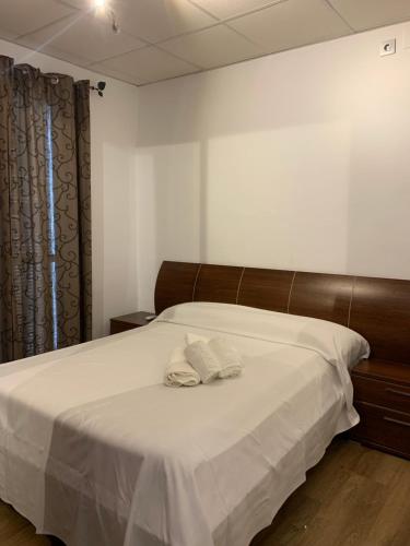 a bedroom with a bed with two towels on it at Apartment Triana 2 in Seville