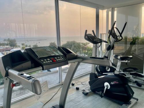 a gym with a treadmill and a phone in a room at Love on top @ The Blu X bangsaen in Ban Bang Saen (1)