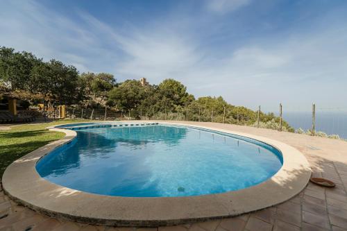 a large pool with blue water in a yard at Casa Tramuntana in Valldemossa