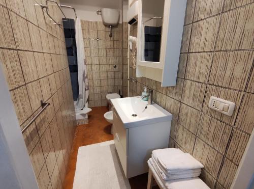 a bathroom with a sink and a toilet and a mirror at AL 171 Locazione Turistica a 50mt metro B1 in Rome
