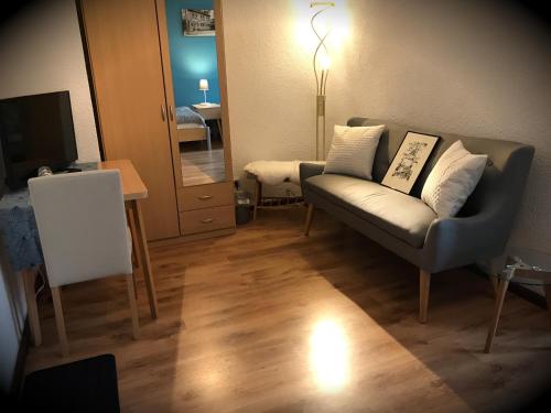 a living room with a chair and a mirror at Alte Druckerei in Quedlinburg