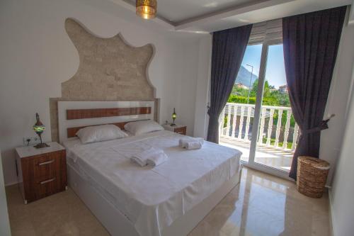 a bedroom with a large bed with towels on it at Hanımeli Villa, Özel Havuzlu, Fethiye in Fethiye
