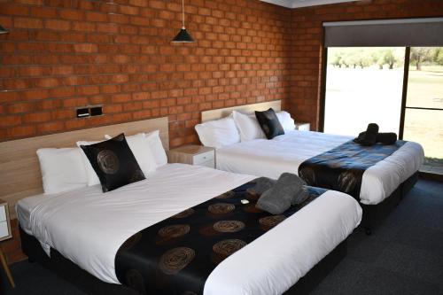 Ένα ή περισσότερα κρεβάτια σε δωμάτιο στο Berrigan Motel