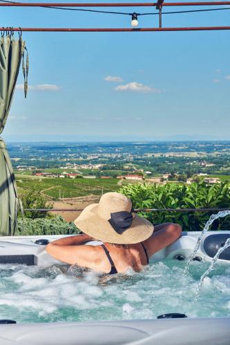 a person in a swimming pool with a hat at La Suite in Chiroubles