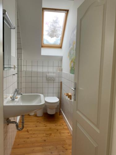 a bathroom with a sink and a toilet and a window at Wohnen im Grünen in der Nähe von Leipzig in Machern