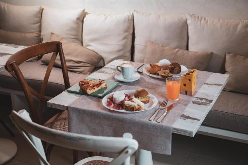 a table with two plates of food on it at Palazzo Fontana B&B e SPA in Gravina in Puglia