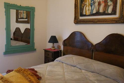 a bedroom with a bed and a mirror on the wall at Agriturismo alle Torricelle in Verona