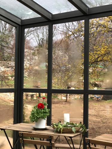 a window with a table with a flower on it at KATIKIA ZAGORI in Vitsa