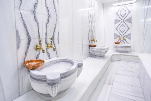a white bathroom with a tub and a sink at Destiny Marine Hotel in Istanbul