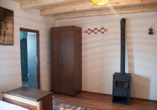 a living room with a wood stove in it at Aste Guesthouse in Tropojë