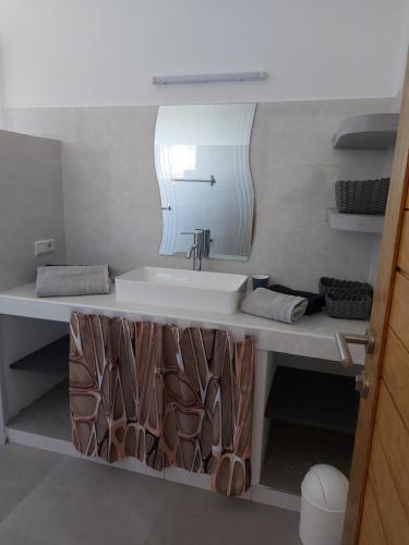 a bathroom with a sink and a mirror at Keur M et M in Saly Portudal