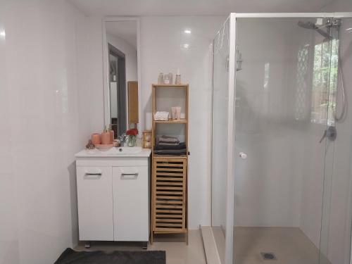 a bathroom with a shower and a sink and a mirror at Oasis at Burringbar waterfront holiday 