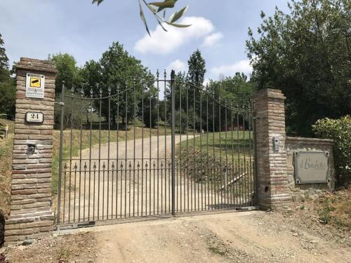 a gate to a driveway with at Casa Lucchese al Borghetto in Collodi