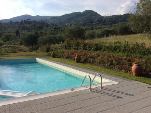 a swimming pool with a view of a mountain at Casa Lucchese al Borghetto in Collodi