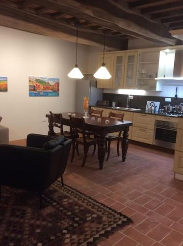 a kitchen with a table and a dining room at Casa Lucchese al Borghetto in Collodi
