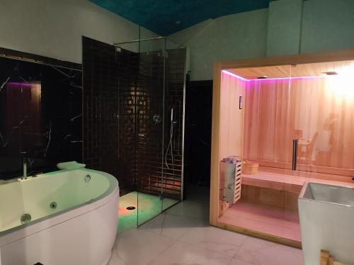 y baño con bañera, ducha y bañera. en Setteabbracci Suite & Apartments, en Baronissi
