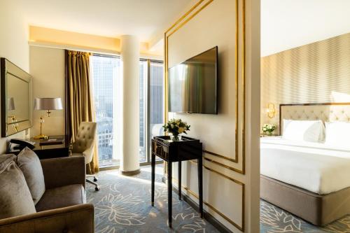 a hotel room with a bed and a desk at Hotel Saint London in London
