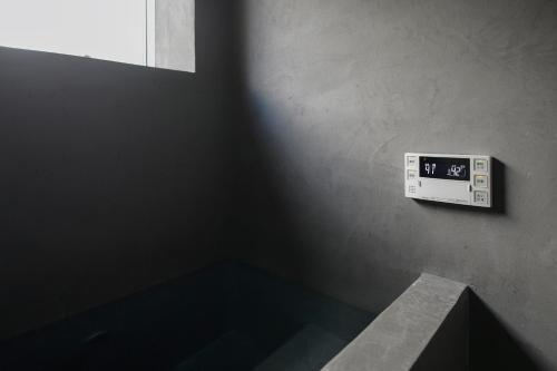 a bathroom with a clock on the wall at Shirafuji in Suzaka