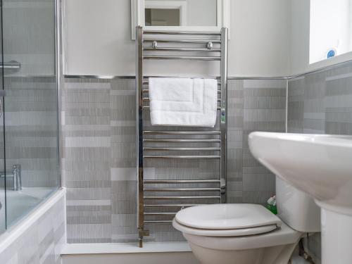 a bathroom with a toilet and a sink at East House - 3 bedroom- Stakeford, Northumberland in Hirst