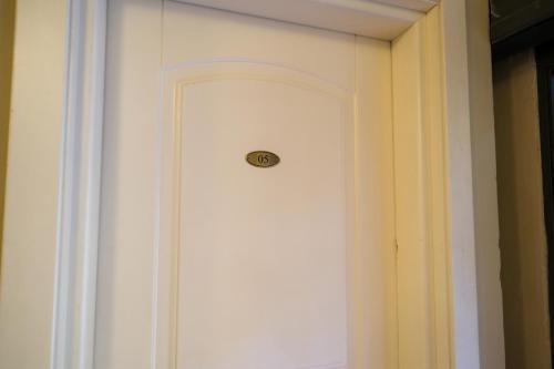 a white door with a lock on a wall at San Tommaso in Pisa