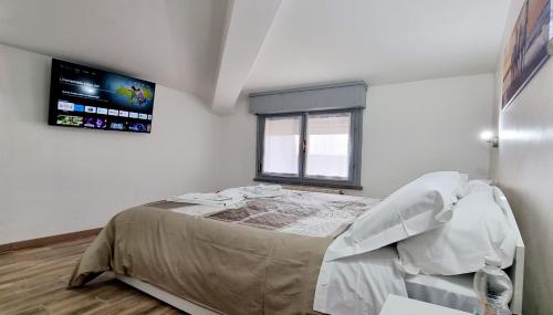 a bedroom with a bed and a window at Guest Holiday Mandra 12 e 13 in Reggio Emilia
