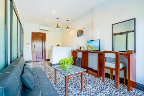 a living room with a couch and a table at Kampot Sweet Boutique in Kampot