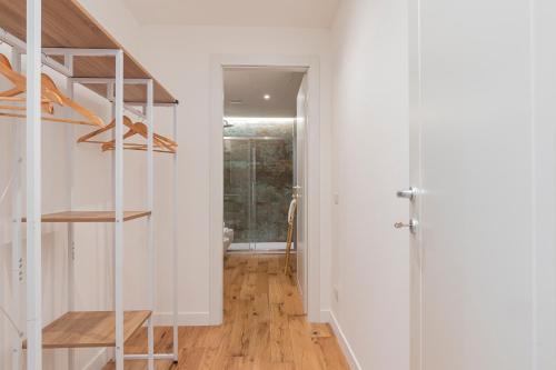 - un couloir avec des murs blancs et un escalier revêtu de parquet dans l'établissement Milan Center Apartment Studio - Porta Romana, à Milan
