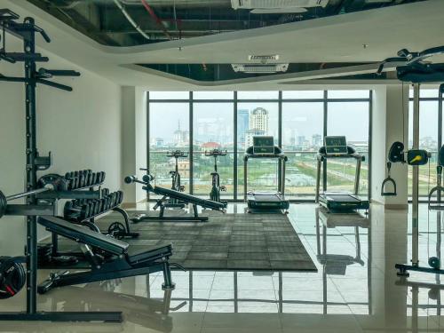 a gym with tread machines and a view of the city at Noric homestay in Hue