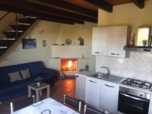 a kitchen and living room with a couch and a fireplace at Chalet San Massimo in San Massimo