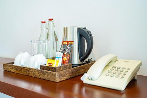 a telephone sitting on a table next to a coffee maker at Kampot Sweet Boutique in Kampot