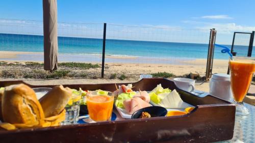 a tray of food on a table next to the beach at Your ¥achting Home in Sousse